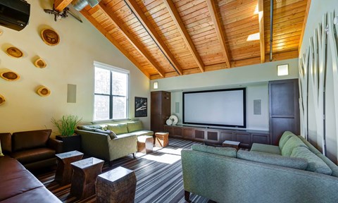 a living room filled with furniture and a large flat screen tv at The Lakes Apartments, Washington